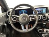 the interior of a car with a steering wheel and dashboard controls
