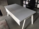a white desk with a black chair next to it