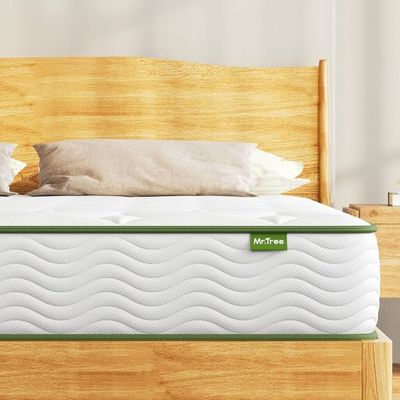a close up of a mattress on a wooden bed frame