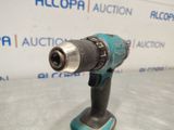 an electric drill is shown on a table in front of a sign