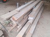 a pile of wood sitting in a yard next to a fork