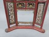 a red table with a mirror on top of it