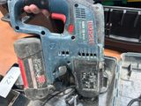 a person holding a cordless drill in their hand