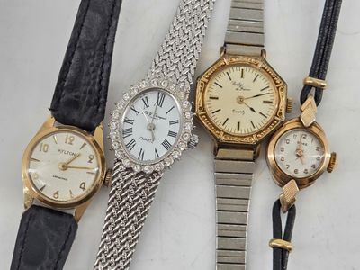 three ladies ' s wrist watches and a ladies ' s watch on a white surface