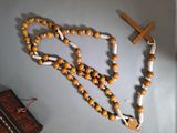 a rosary and a wooden cross hanging on a wall