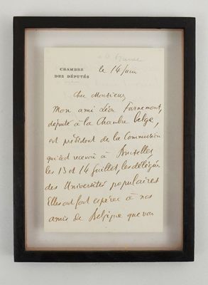 framed photograph of a handwritten letter in a black frame on a white wall