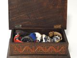 a wooden box filled with assorted items on a white surface