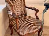 a zebra print chair in a bathroom next to a bathtub