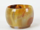 a brown and yellow bowl sitting on a white surface