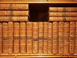 many old books on a shelf in the room