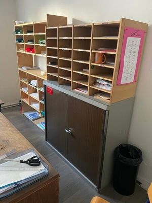 a desk with a bunch of papers on it in a room