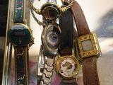 many different types of watches on display in a glass case