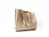 a beige leather tote bag on a white background