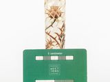 a glass vase sitting on top of a green card