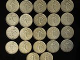 a lot of silver coins on a black surface