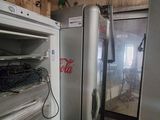 a refrigerator and a refrigerator freezer in a room