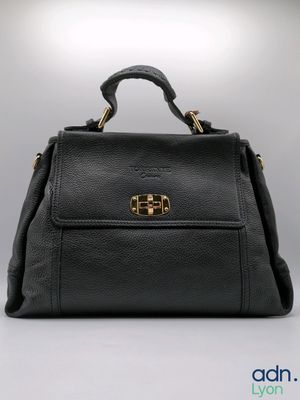 a black leather handbag with gold hardware on the handle