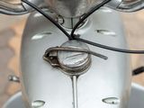a close up of a motor bike with a metal handlebar
