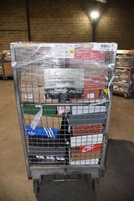 a metal cart with many items in it in a warehouse