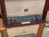 an old radio sitting on top of a wooden table