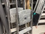 a pile of chairs and ladders in a room