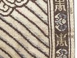 an image of a close up of a rug on a white surface