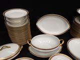 a lot of plates and bowls on the table