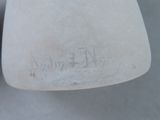 a close up of a white vase with writing on it