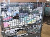 a metal cart with many items in it in a warehouse