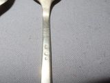 two spoons that are sitting on a table