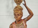 a statue of a woman with a pot on her head