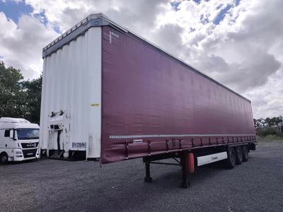two semi trucks parked next to each other in a parking lot