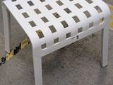 a white chair that is chained to a yellow rope