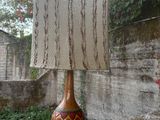 a lamp that is sitting on top of a cement wall