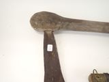 an old axe and a key on a white table