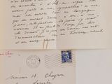 an old envelope with a letter and a postcard on top of it
