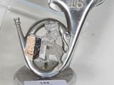 a silver sculpture of a man playing a musical instrument