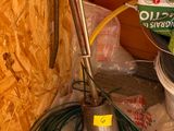 an image of a pile of gardening equipment in a room