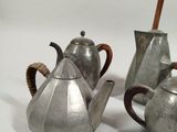 three silver teapots sitting next to each other on a table
