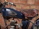 a motorcycle that is parked in front of a brick wall