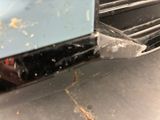a close up of a car ' s front bumper with rust on it