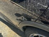 a close up of a car door handle on the side of the road