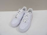 a pair of white sneakers on a white surface
