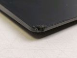 a close up of a laptop with a hole in the back