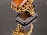 une bague en or surmontée d'une pierre orange