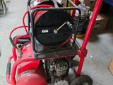 a small red fire hydrant sitting in a garage