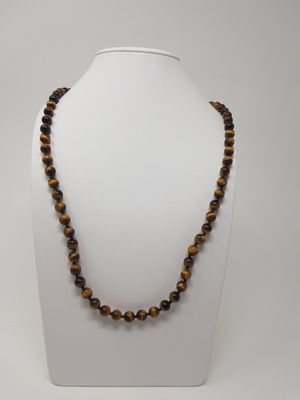 a tiger eye beaded necklace on a white mannequin