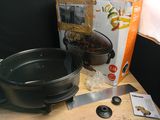 a box of food sitting on a table next to a pot and pan