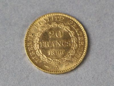 a close up of a gold coin on a white surface