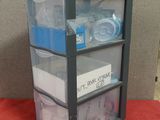a picture of a three tiered storage unit with plastic bins